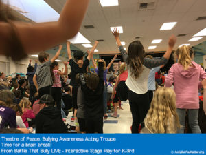 Photo of Theatre of Peace leading students in a brain break partway through Baffle That Bully Live. Part of Baffle That Bully LIVE - Interactive Stage Play for K-3rd.