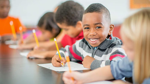 Young student working on the handout in class